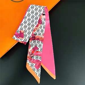 Detail view of double-sided silk twilly scarf with pink satin back and abstract art prints