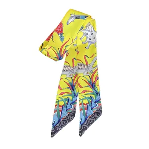 Elegant yellow silk twilly scarf featuring elephant and crocodile animal prints