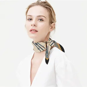 Silk scarf with belt and chain print in beige and orange on a female model