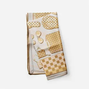 Dettaglio del foulard di seta piegato con illustrazioni di moda e bordi arrotolati marroni
