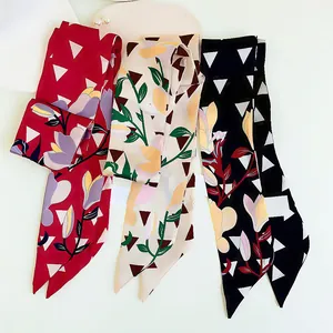 Red, beige, and black floral twilly scarves with geometric patterns for bags and hair