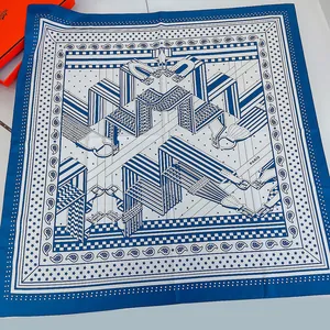 Detail of blue and white square silk scarf with classic horse harness pattern and hand-rolled edge