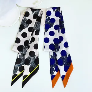 Narrow silk scarves with rose and polka dot prints on a stylish white hat background