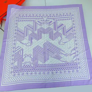 Detailed macro view of hand-rolled edges on a silk square scarf with purple print