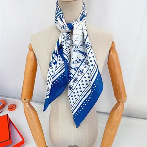 French style blue and white equestrian print satin silk scarf on a wooden stand