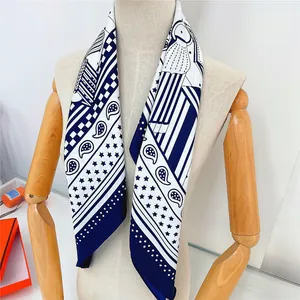 Detail of hand-rolled edges and paisley pattern on blue and white silk scarf