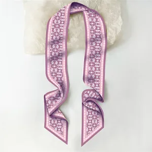 Close-up of purple paisley long silk scarf with intricate geometric edge patterns