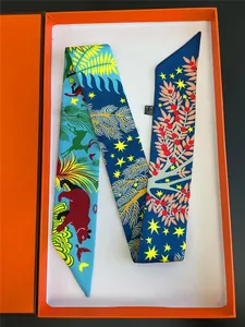 Detail view of colorful jungle animal silk scarf twilly inside an orange gift box