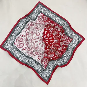 Detail of red and black paisley print square scarf showing fabric texture and patterns