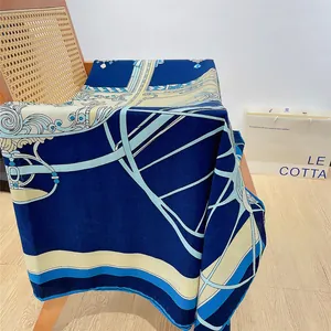 Classic blue European style oversized silk shawl with carriage patterns on a chair