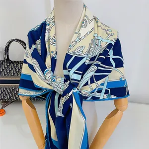 Detailed drape of thick navy blue and beige scarf with European horse carriage patterns