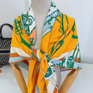 Detailed view of the yellow baroque horse carriage pattern on the luxury silk shawl scarf