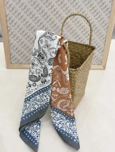 Detail showing paisley pattern silk scarf with contrast patchwork colors and soft texture