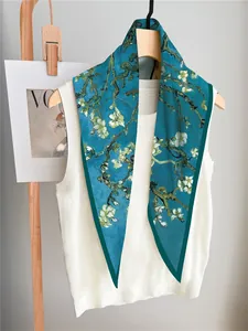 Detailed macro view of Van Gogh almond blossom print on a light blue luxury silk scarf