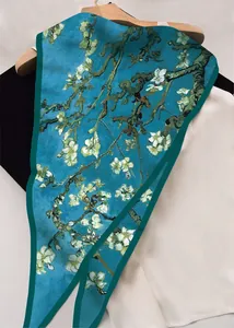 Detail of Van Gogh Almond Blossom print scarf with elegant satin finish on a wooden hanger