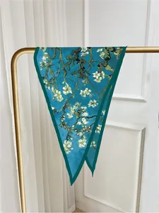 Artistic Van Gogh Almond Blossom silk scarf displayed on a golden metal rack