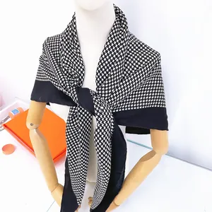 Classic black and white houndstooth oversized scarf shawl displayed on a studio mannequin
