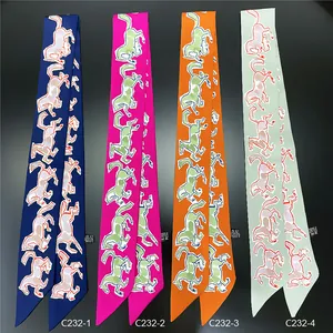 Flat lay of colorful polyester twilly scarves with abstract horse patterns on black background