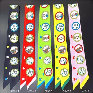 Vue à plat de foulards twilly colorés à motif cœur en noir, rouge, vert, jaune et rose
