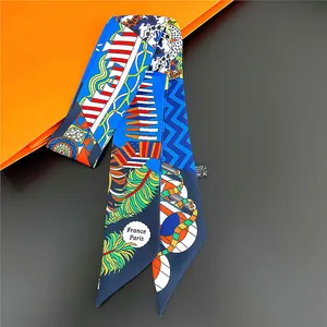 Detailed close-up of a colorful twilly scarf with floral patterns and geometric waves