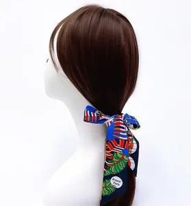 Floral royal blue skinny silk scarf for women styled as a headband on a white model bust