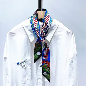 Detail of floral skinny scarf with France Paris print styled on a white shirt collar
