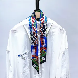 Floral print silk scarf with France Paris text tied on white shirt collar close-up