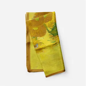 Close-up of artistic Van Gogh sunflower oil painting print on a yellow silk scarf