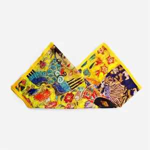 Detail of Klimt silk scarf showing vibrant yellow fabric and artistic floral pattern