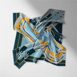 Close-up of luxury silk scarf featuring artistic belt buckle prints and twill texture