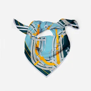 Detail of silk scarf with equestrian patterns and hand-rolled edges in blue and yellow