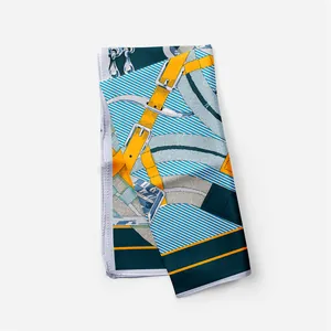 Detail of silk scarf with luxury horse harness pattern and vibrant yellow belt buckle design