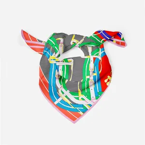 Detailed view of luxury silk scarf with equestrian horse bit pattern and vibrant colors