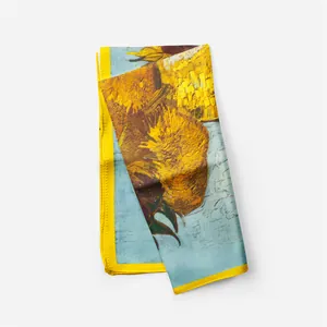 Detail of Van Gogh sunflower silk scarf showing fine print texture and yellow hemmed edges
