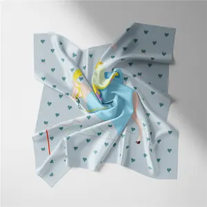 Detail view of a 53cm light blue silk square scarf with horse print and heart pattern