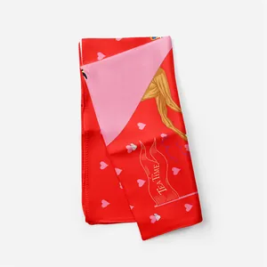 Detail of red silk scarf showing tea time illustrations and pink heart patterns