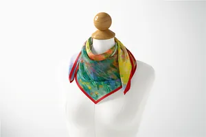 Detailed macro view of the impressionist oil painting pattern and red rolled edges on silk scarf