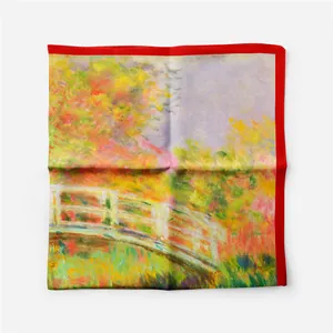 Detail of Monet Japanese Bridge silk scarf featuring vibrant oil painting and red borders