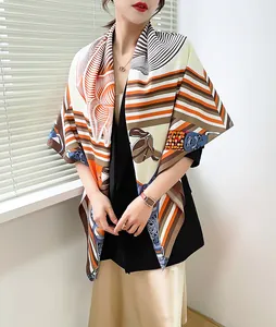 Detail of vintage geometric horse print silk scarf styled over a black suit blazer