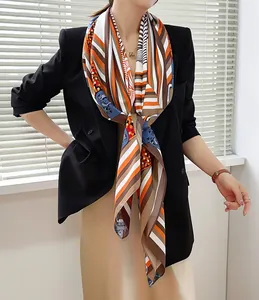 Detail of elegant retro horse head and striped silk scarf styled with a black blazer