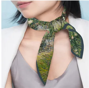 Detail of artistic Van Gogh style floral silk scarf styled with a white blazer