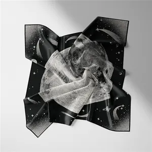Detailed view of silk square scarf featuring celestial moon and star patterns