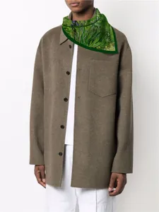 Close-up of Green Iris silk scarf with Van Gogh art pattern on a brown wool coat