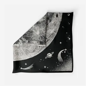 Detailed close-up of silk scarf showing astronomical moon and planet print textures