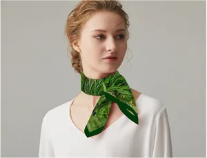 Detail of green Van Gogh iris oil painting silk scarf tied elegantly on a model