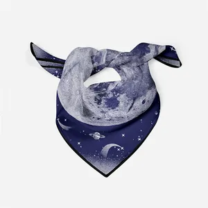 Detail showing high-quality silk scarf with moon and planet print in deep blue and white