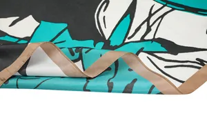 Detail of hand-painted rose pattern and satin stitched edges on silk feel scarf