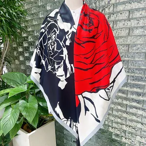 Detail of 130cm square silk scarf with hand-painted red rose patterns on a mannequin