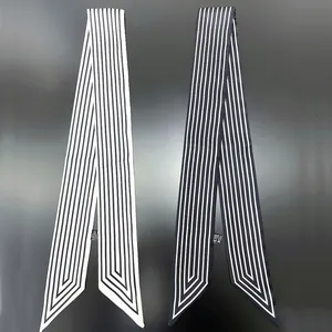 Detail of minimalist geometric striped twilly scarves showing fabric texture and wash label