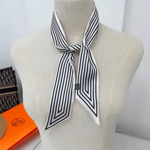 Detail of black and white striped twilly silk scarf tied on a mannequin neck
